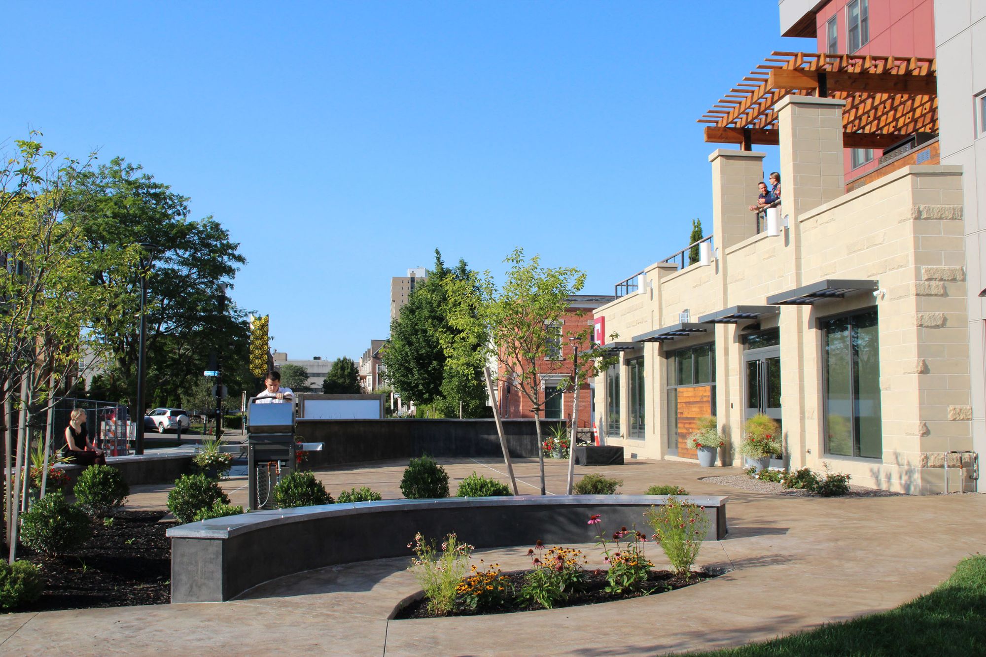 The pocket park beside the building, with grills and seating