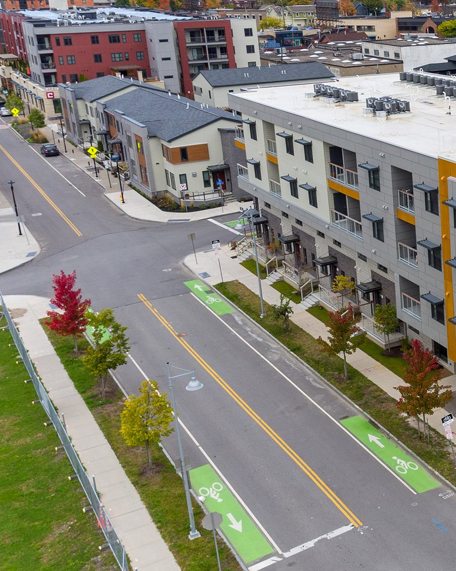 Green bike lanes, crosswalks and tree-lined sidewalks on the streets around Charlotte Square